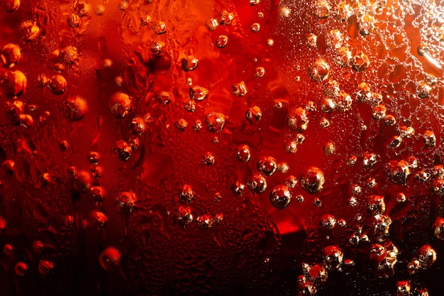Cola avec fond de glace alimentaire élément de conception gros plan Cola bulles de bière macro