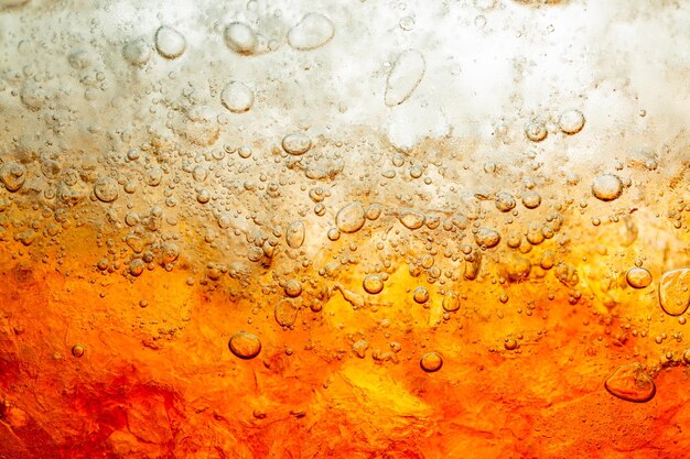 Cola avec fond de glace alimentaire élément de conception gros plan Cola bulles de bière macro