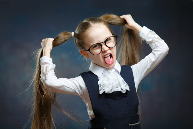 Écolière, porter, uniforme, lunettes, jouer, singe, portrait