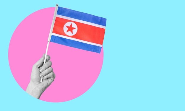 Collage d'art contemporain La main d'une femme tient le drapeau de la Corée du Nord