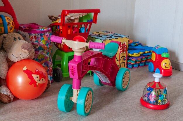 Collection de jouets pour enfants par terre dans la chambre