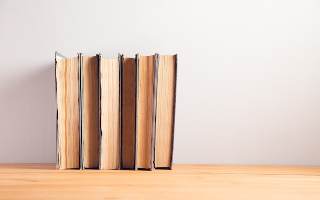 Collection de vieux livres sur fond de table en bois