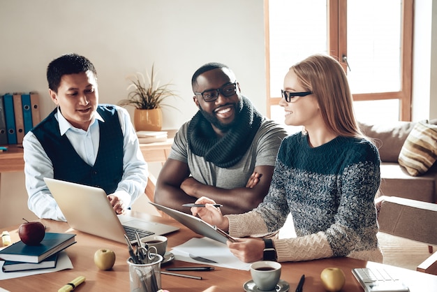 Photo des collègues multiraciaux travaillent ensemble sur le projet.