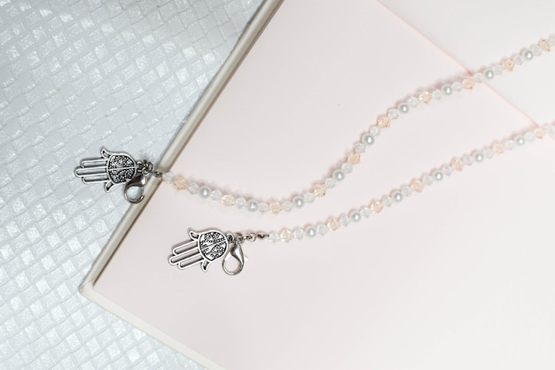 Photo collier de perles à la mode avec fond de livre rose