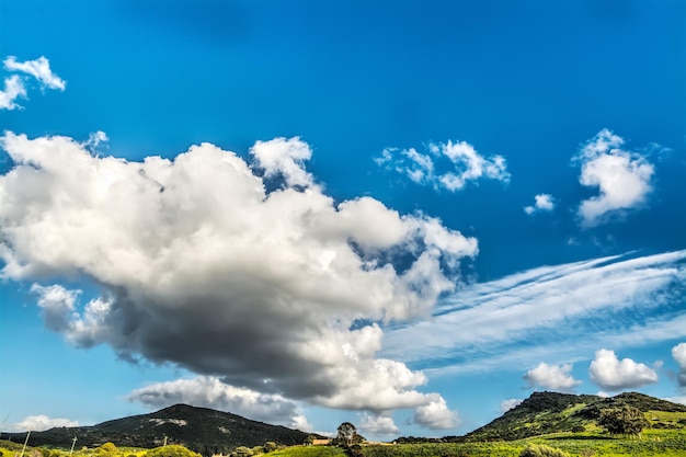 Collines verdoyantes sous un ciel bleu avec des nuages en Sardaigne Italie