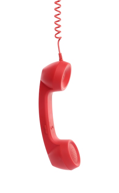 Combiné de téléphone filaire rouge accroché sur fond blanc concept Hotline