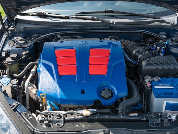 Photo compartiment de véhicule à capot de voiture ouvert avec moteur recouvert d'un couvercle en plastique brillant