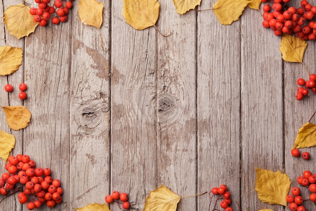 Photo composition d'automne avec de belles feuilles jaunes sur fond en bois. vue de dessus, mise à plat, tonification vintage. concept de détente automne