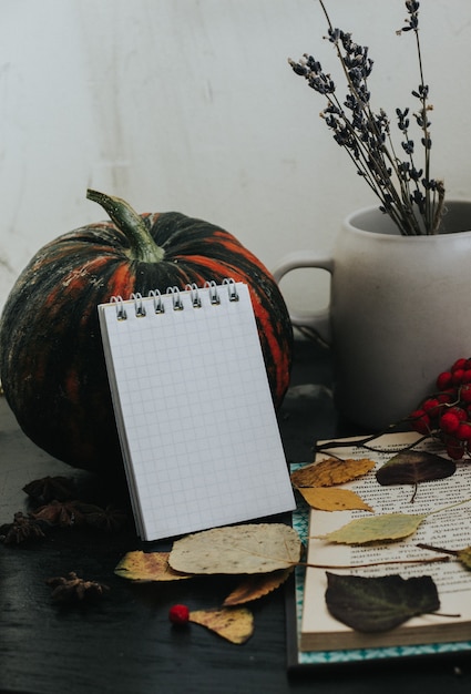 composition d'automne sur fond sombre, atmosphère chaleureuse, thé, livres, feuillage