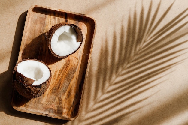 Photo composition créative abstraite d'été avec noix de coco a sur plateau en bois sur papier kraft