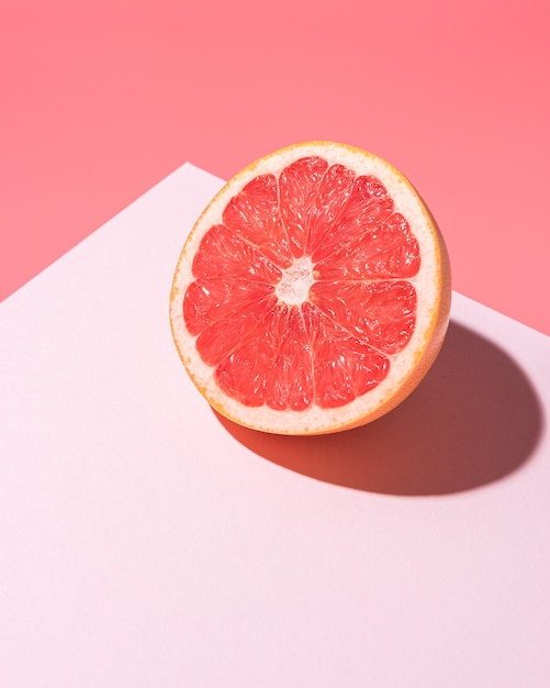 Composition de fruits créative sur rose avec des ombres dures