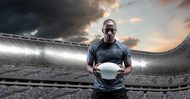 Photo composition d'un joueur de rugby masculin tenant un ballon de rugby sur un stade de sport