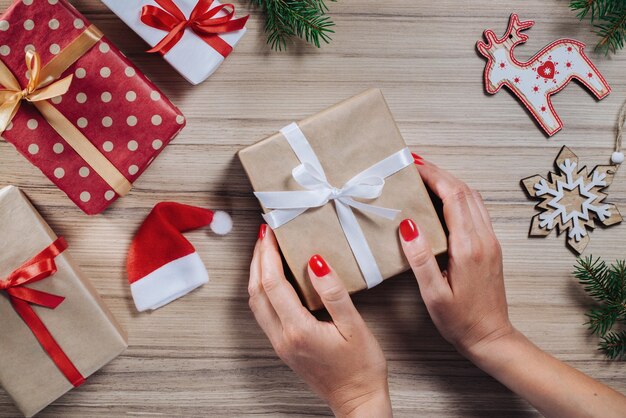 Composition de Noël de coffrets cadeaux, branches de pin et coffrets cadeaux sur table en bois