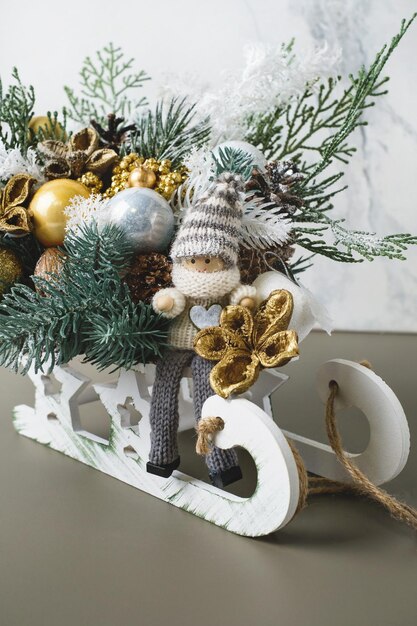 Composition de Noël dans un traîneau en bois avec un elfe