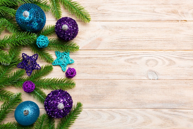 Composition de Noël faite de sapin, boules et différentes décorations sur bois.