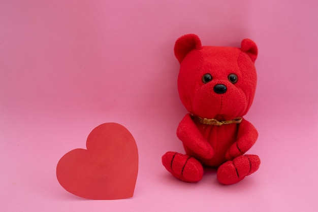 Composition Ours en peluche et coeur en rouge sur rose