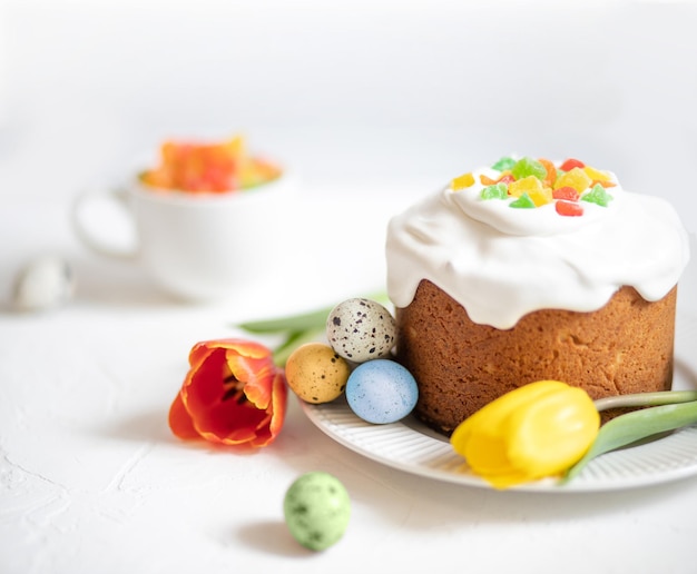 Composition de pâques avec gâteau de pâques traditionnel peint oeufs de caille et tulipes