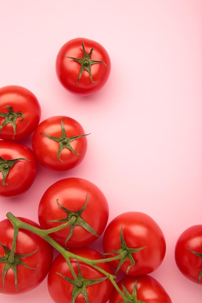 Composition à plat avec bouquet de tomates sur fond rose Photo verticale