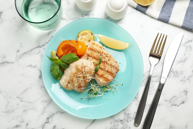 Composition à plat avec poisson grillé sur table en marbre