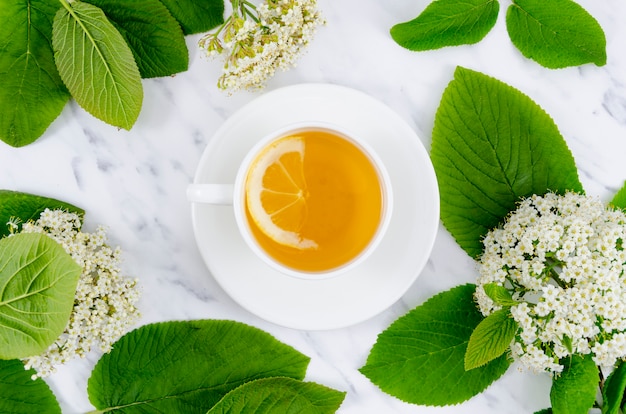 Photo composition de thé à plat avec fleurs