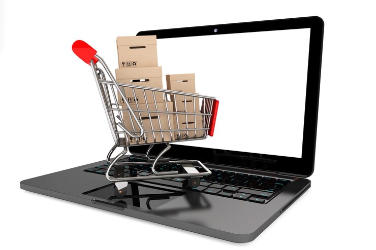 Photo concept d'achat en ligne. panier avec des boîtes sur un ordinateur portable sur un fond blanc