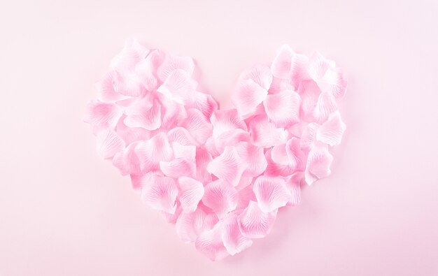 Concept d'amour et de la Saint-Valentin. Coeurs roses faits de pétales de rose sur fond pastel