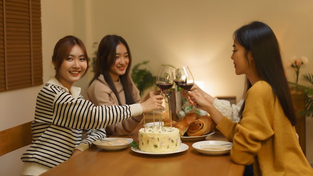 Concept de célébration d'anniversaire Filles asiatiques faisant tinter du vin en verre au dîner pour célébrer la fête d'anniversaire