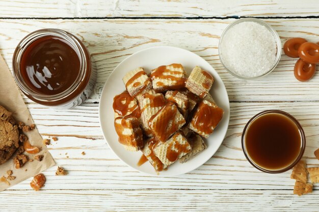 Concept de collation savoureuse avec des cookies au caramel sur une table en bois blanc