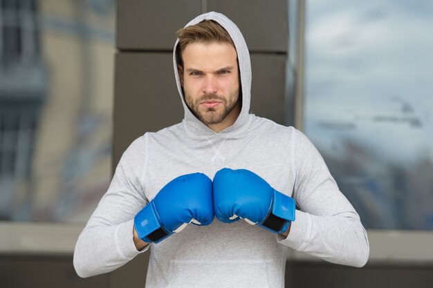 Concept de combat Homme boxeur prêt pour le combat Le sportif porte des gants de boxe dans le club de combat Le combat