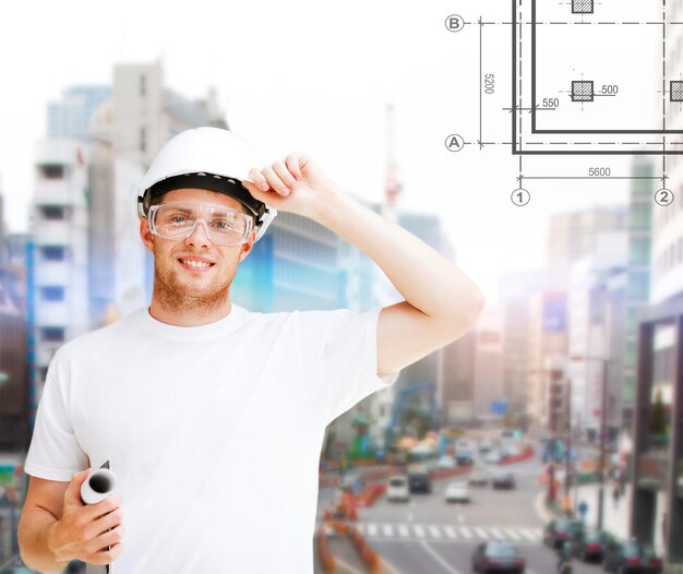 concept de construction, de développement, de construction et d'architecture - architecte masculin en casque avec plan et lunettes de sécurité