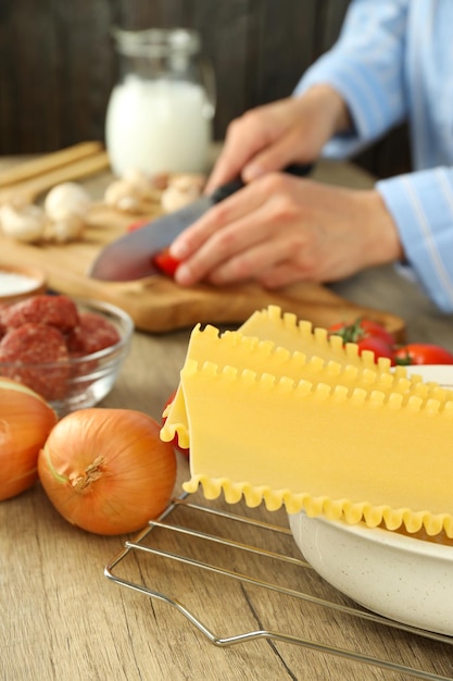 Concept de cuisine femme en chemise cuisinant des lasagnes