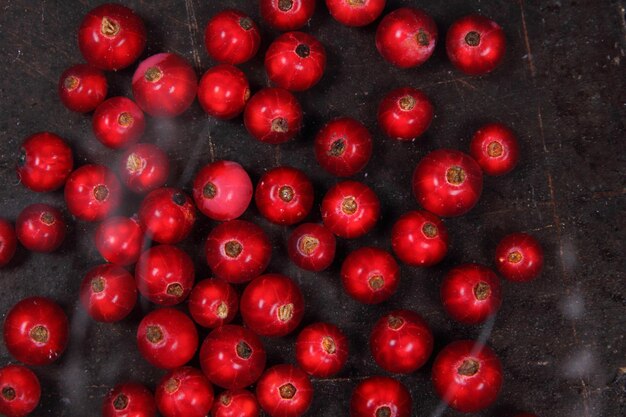 Concept de cuisine végétarienne Groseilles rouges juteuses sucrées sur fond sombre Vue de dessus Gros plan