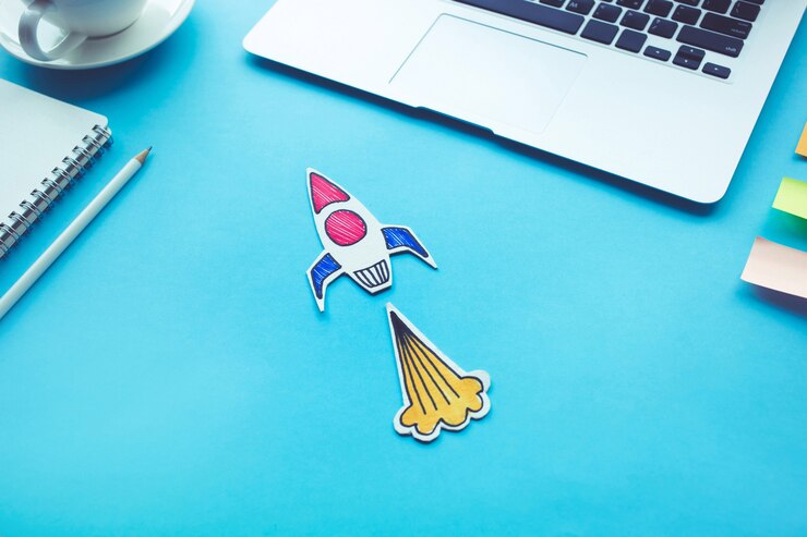 Photo concept de démarrage d'entreprise avec fusée sur la couleur de la table de bureau