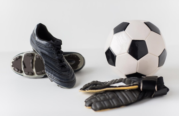 Photo concept d'équipement de sport, de football, de football et de sport - gros plan sur le ballon, les bottes et les gants de gardien de but