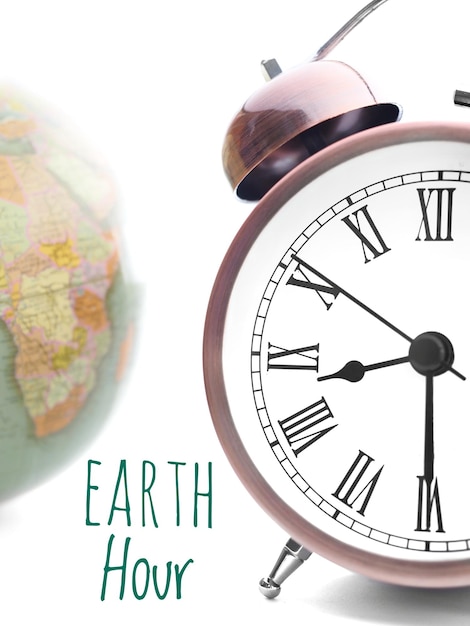 Photo concept d'heure de la terre horloge de réveil à 20h30 et globe