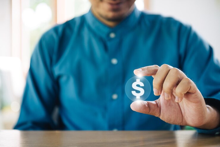 Photo concept d'investissement financier international réussi avec un homme d'affaires détenant des courbes de croissance de signe dollar brillant et une technologie numérique de signe dollar