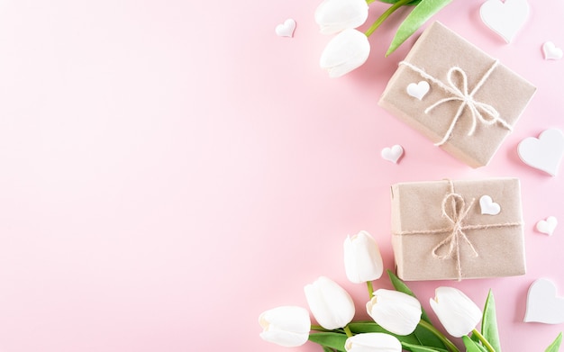 Concept de la journée des femmes heureux, belles tulipes, coffret cadeau avec coeur sur pastel