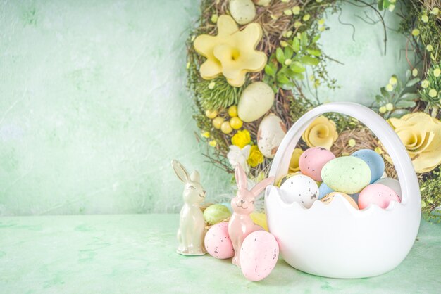 Concept de Joyeuses Pâques avec des oeufs de Pâques dans le panier et des fleurs de printemps. Fond de Pâques avec espace copie et cadre photo