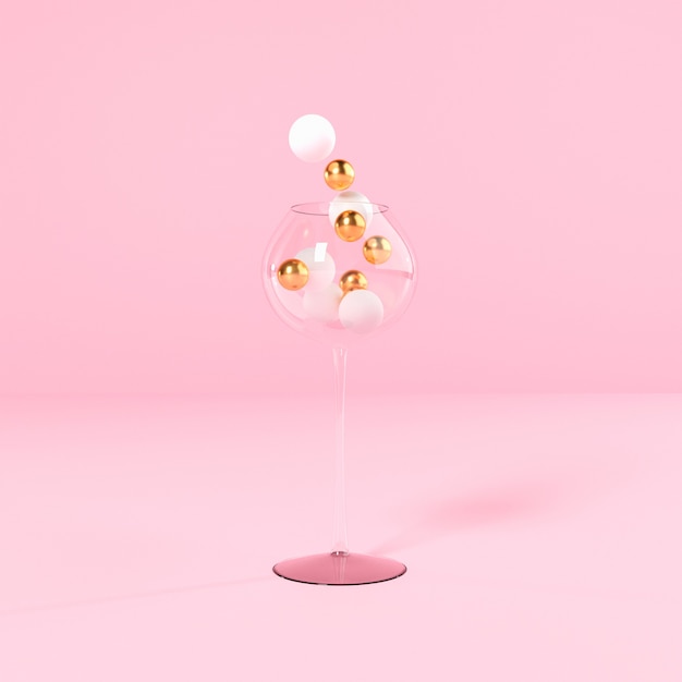 Concept de Noël, verre avec des boules sur fond rose, espace copie