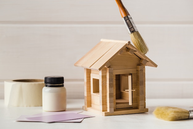 Concept de peinture de maison en bois jouet sur blanc