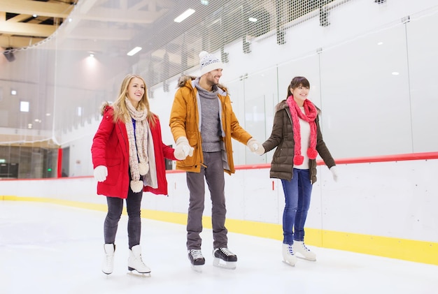 concept de personnes, d'amitié, de sport et de loisirs - amis heureux sur la patinoire