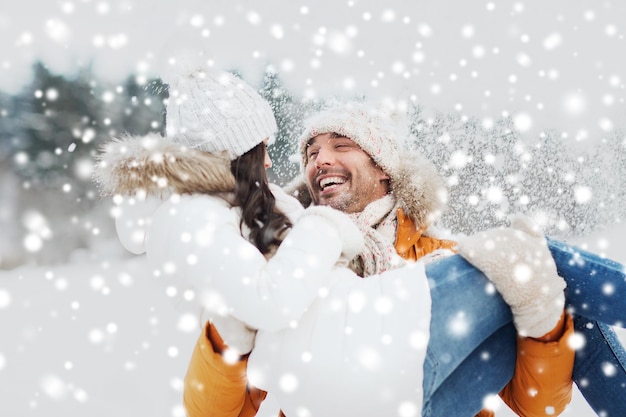 Photo concept de personnes, de saison, d'amour et de loisirs - couple heureux à l'extérieur en hiver