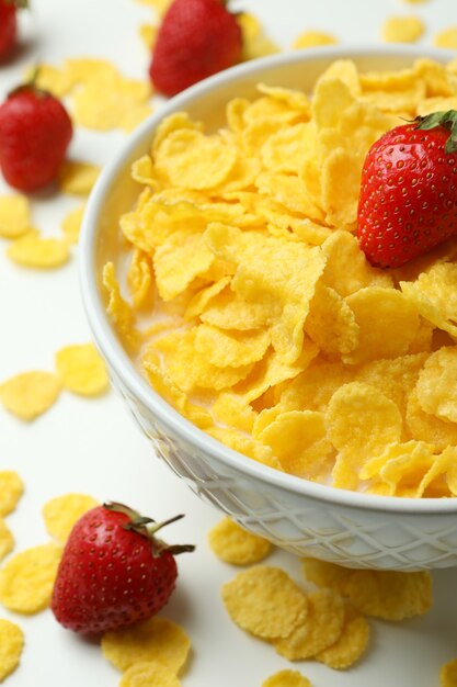 Concept de petit déjeuner savoureux avec cornflakes et fraise sur fond blanc