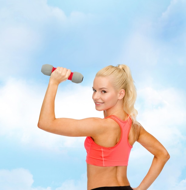 concept de remise en forme, de sport et de régime - jeune femme sportive avec haltère léger