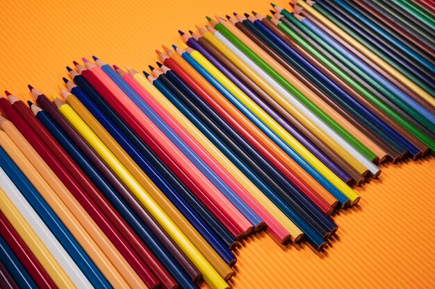 Concept De Retour à L'école. Crayons De Couleur Sur Fond Orange.