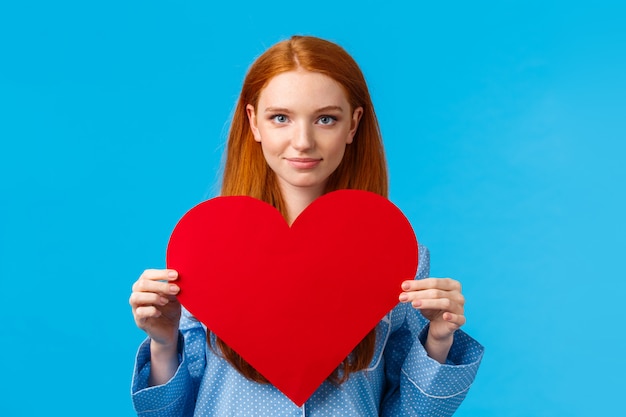 Concept de la Saint-Valentin. Femme rousse mignonne confiante et audacieuse