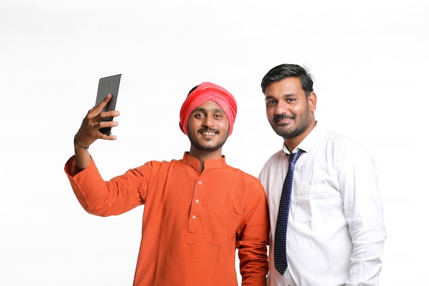 Concept technologique : agriculteur indien prenant selfie avec officier