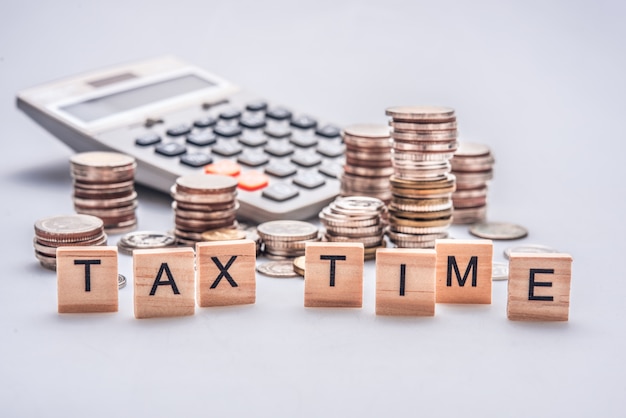 Concept De Temps De Taxe Avec Des Blocs De Bois Et Des Pièces De Monnaie Sur Fond Blanc