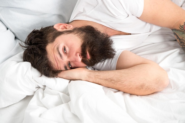 Concept de troubles du sommeil Quelle longue nuit Homme hipster barbu ayant des problèmes de sommeil Un gars allongé dans son lit essaie de se détendre et de s'endormir Techniques de relaxation Violations du sommeil et de l'éveil