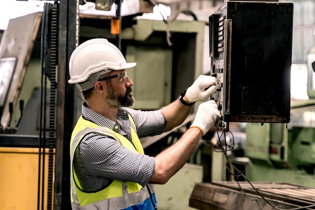 Concept d'usine industrielle. Technicien en ingénierie ou ouvrier opérant et entretenant des machines.